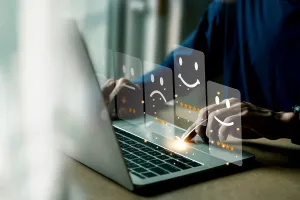 Person typing on a laptop responding to customer reviews