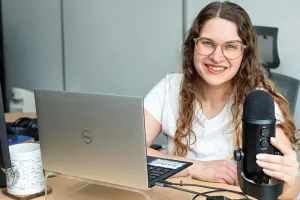 sammie Walker Herrera at their laptop with audio mic